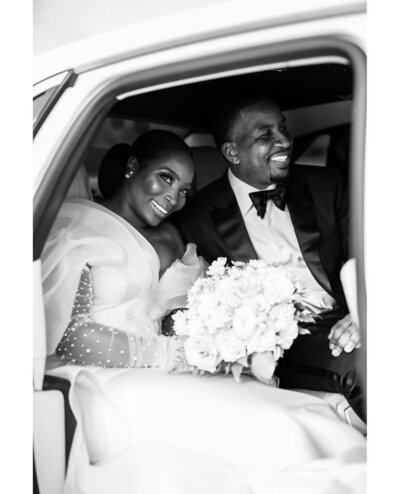 Bride and groom in getaway car after Dallas wedding by White Orchid Photography