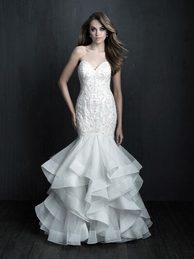 A smooth satin finish paired with tiered ruffles lends itself to a truly statuesque strapless gown.