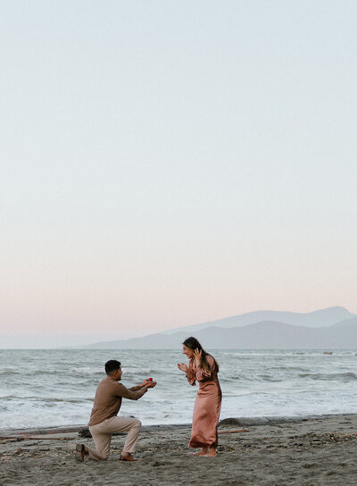 Vancouver engagement photographer capturing couples surprise proposal in Wreck Beach Vancouver