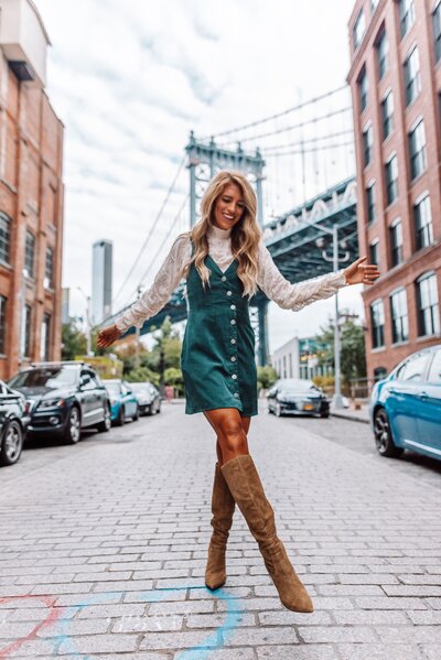 Blonde girl with boots on brick road