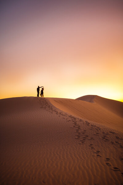 elopement on top of large sand dunes with a sunset