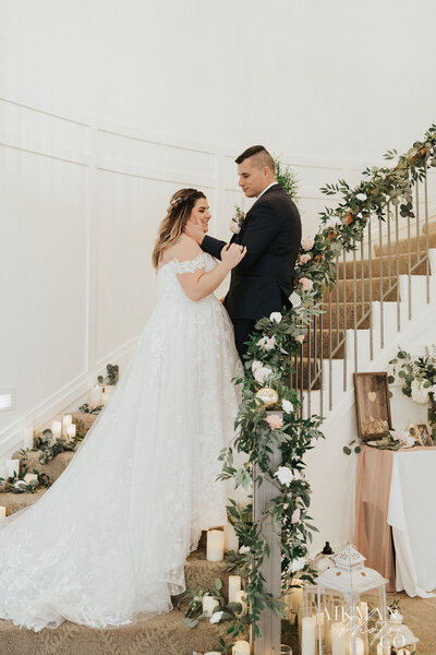 couple standing on staircase