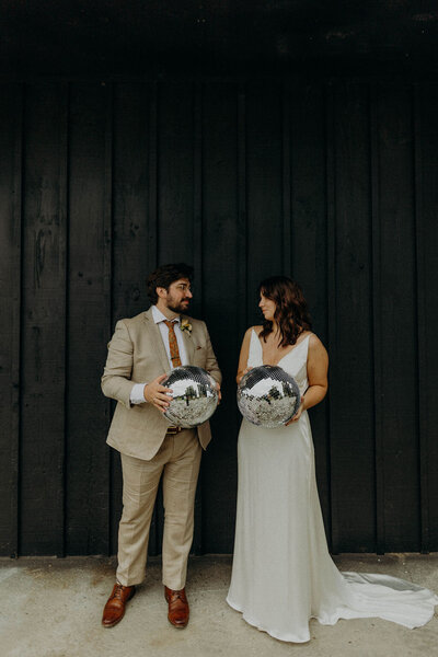 Couple both holding disco balls - UME (New England Wedding Planner) were a wedding vendor