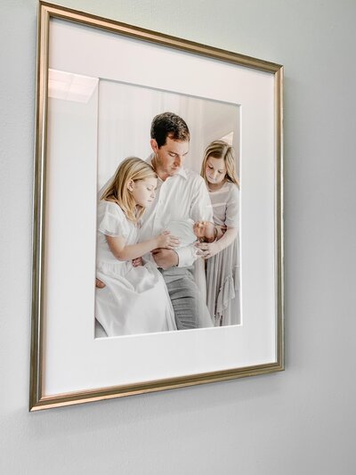 Custom framed newborn photo of dad with kids.
