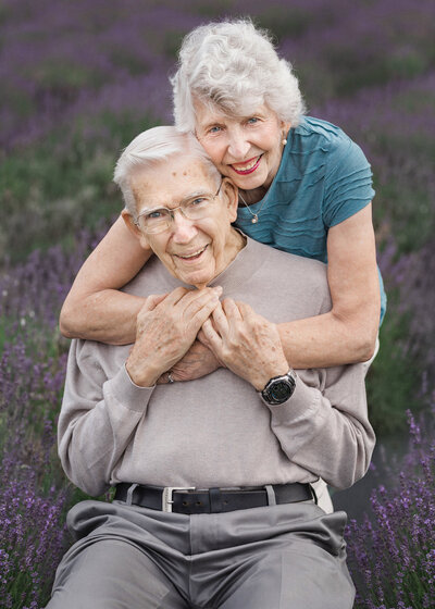 Old married couple hugging in a lavender field in