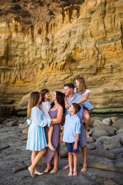 Family splashing in the waves in San Diego by portrait photographer, Loni Brooke Photography