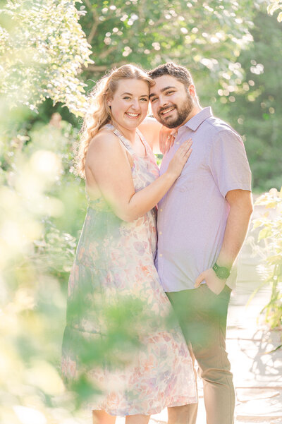A happily engaged couple in a Raleigh park at sunset by JoLynn Photography, a Raleigh wedding photographer
