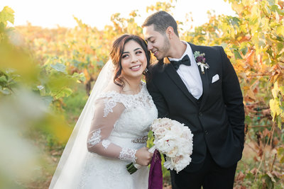 Los Angeles Wedding photographer Marianne Lucas wedding photo. Film photo, greenery bouquet, Oaks room, picture of a sweet heart table with glass surrounding the back of them. Calamigos Ranch Wedding Photographer