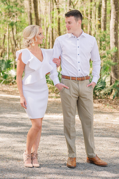 A couple walking down a pathway hand in hand celebrating their Raleigh wedding photos by JoLynn Photography