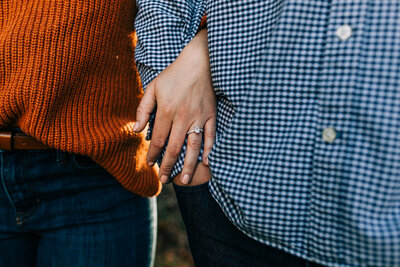 A photo of a couple and the engagement ring