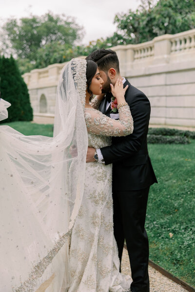 Couple standing together on wedding day holding each other, Rosecliff Mansion Wedding, Unique Melody Events & Design (New England Wedding Planners)