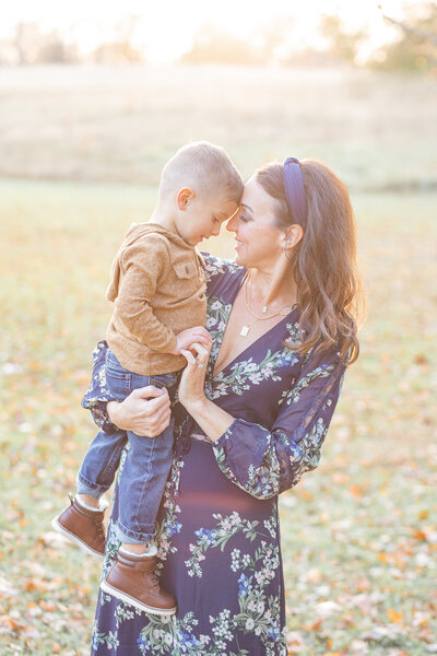 Monmouth Battlefield Park mom hugging young son in blue dress in fall