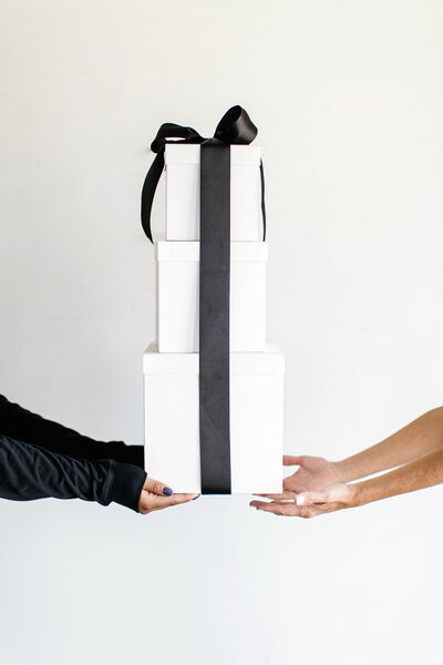 White gift boxes with black ribbon
