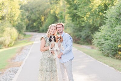 cute Nashville family with 2 dogs posing for photo on the Murfreesboro Greenway