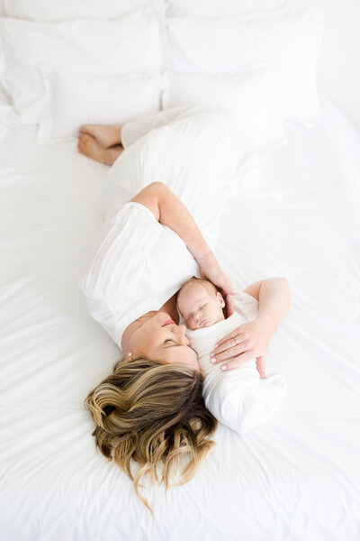 Mom snuggling baby by DC Newborn Photographer