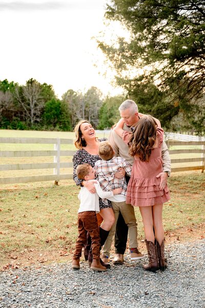 family of five laughing and hugging during their family portrait session