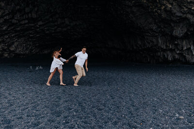 Iceland Elopement photographer captures outdoor elopement of couple running through sand together