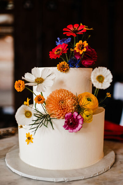 Photo of wedding cake with flowers, Blended wedding at Peirce Farm at Witch Hill