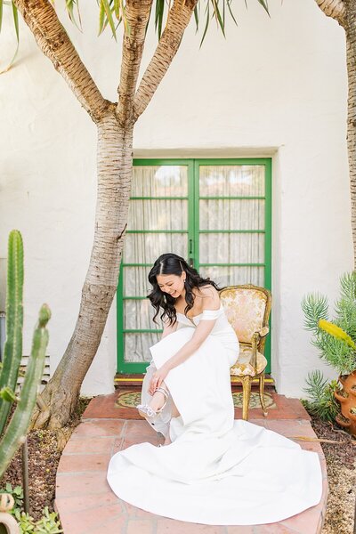 Bride tying shoes at Casa Romantica in San Clemente, California by Sherr Weddings, San Diego Photography and Videography team.