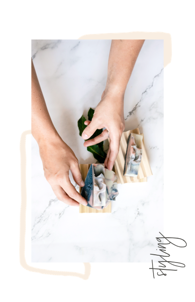 lady's hands arranging soaps for product shoot