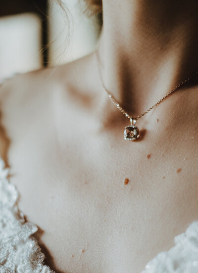 bride's details and jewelry on her wedding day as she gets ready for