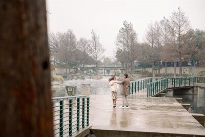 Engagement photos couple playful and twirling on a rainy day at the Pearl