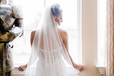 image of bride from behind standing at a window