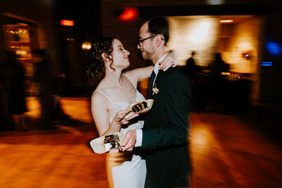 wedding couple eating cake on dance floor