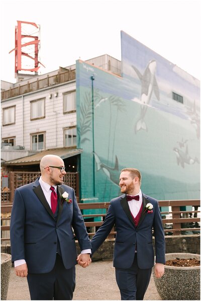 An Edgewater wedding couple in front of orca mural