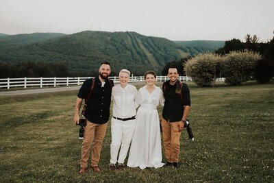 Brides standing with photographers, Berkshire Farm Wedding