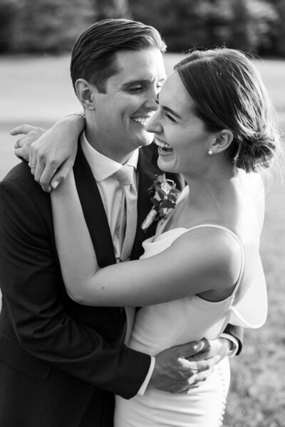 Newly married couple laughing outside of their Philadelphia wedding by Kseniya Berson Photography