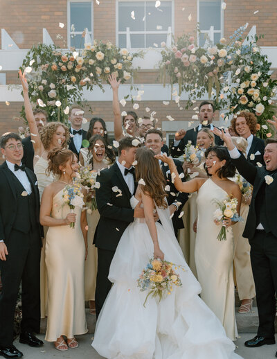 view of a reception table with a tall floral arrangement in the middle and big windows, designed by wedding planners in Cleveland Ohio, Sirpilla Soirees