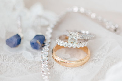 Detail shot of wedding rings and wedding day jewelry