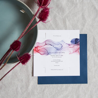 Purple and blue and red ink watercolour wedding invitation design with blue envelope