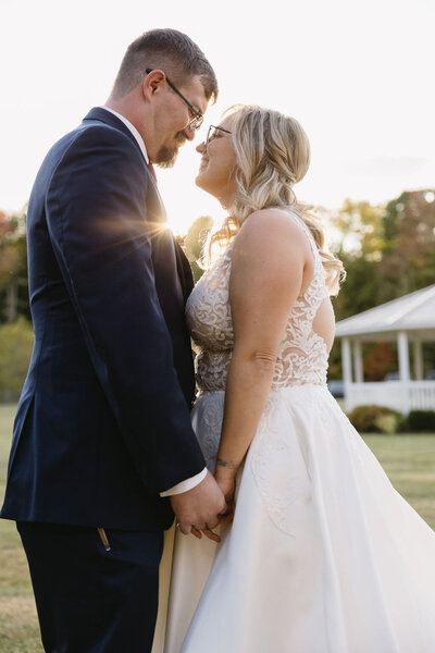 bride and groom holding hands at sunset outdoors