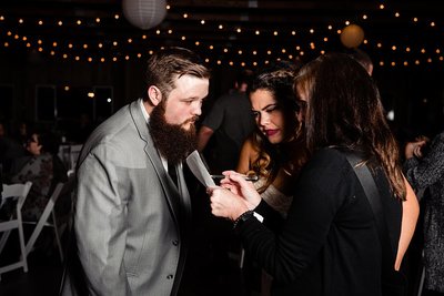 Photographer checking timeline over with bride and groom during reception