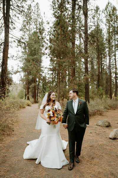 Couple walking in Shevlin Park for their wedding at Aspen Hall in Bend Oregon