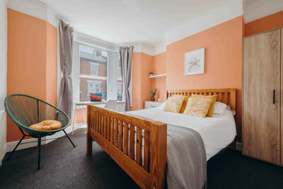 Orange and White Bedroom in Student House Buy To Let Milton Keynes