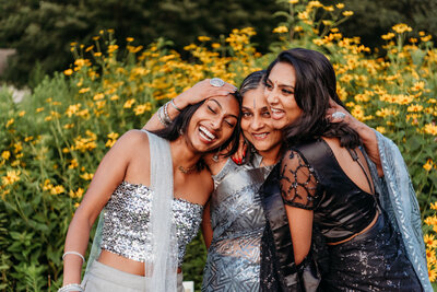mother hugging her two adult daughters  and laughing during their Philadelphia family photography session