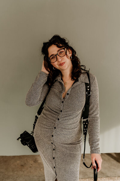 portrait of Emily D'Angola wearing camera harness and holding cane