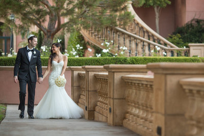 Bride and Groom walking down a pathway at the Fairmont Grand Del Mar