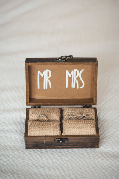 Wedding rings in a wooden box labeled Mr. & Mrs.