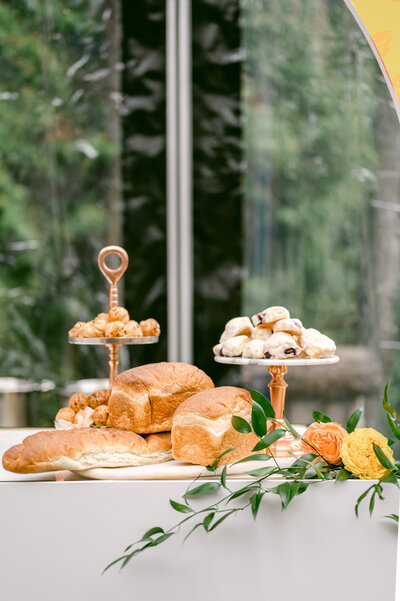 pastries on a white table with orange and yellow flowers