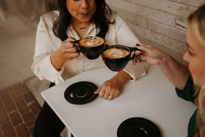 couple toasting with coffee cups at table