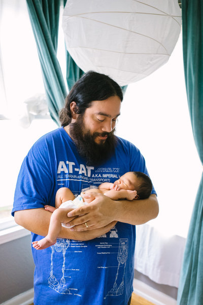 Photo of San Antonio Photographer David Castillo holding his newborn baby