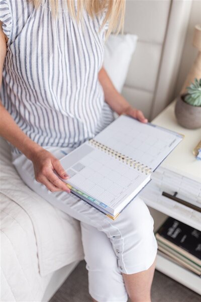woman writing in a planner