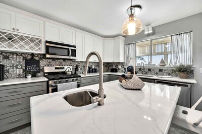 Large kitchen island with seating for two in this 3-bedroom, 2.5 bathroom lake house with incredible view of Lake Belton located at Morgan's Point, near Rogers Park and Temple Lake Park.