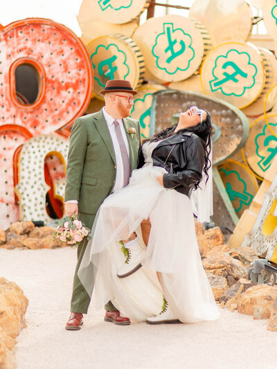 Bride laughs with her husband at the Neon Museum in Las Vegas, NV.