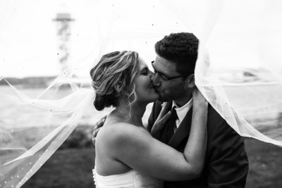 Erie, PA bride and groom kiss during portraits outside the Concourse at Union Station