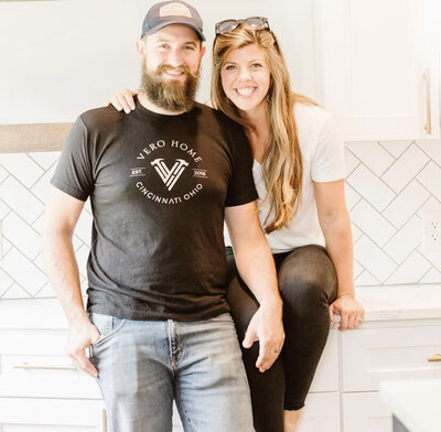 husband and wife smile from their kitchen